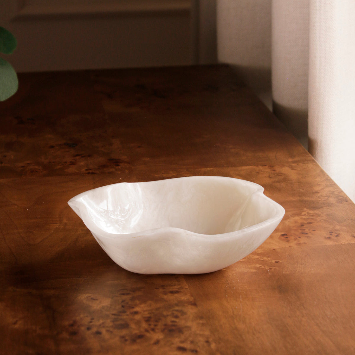 White resin bowl on a wooden surface