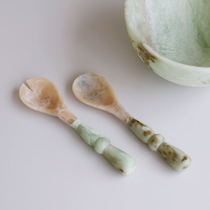 Two Two Salad Servers with jade swirl marble pattern resin handles on a light background