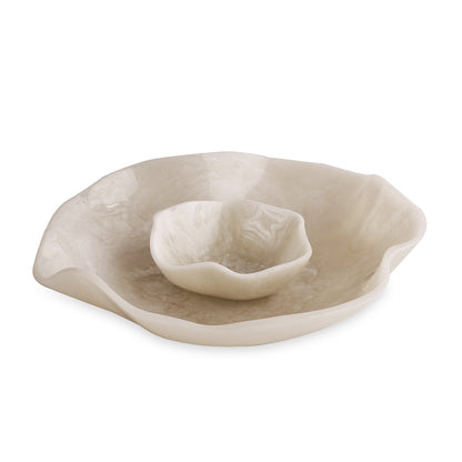 White resin dish with a smaller white dish inside on a white background