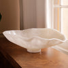 White resin bowl on a wooden surface with a neutral background